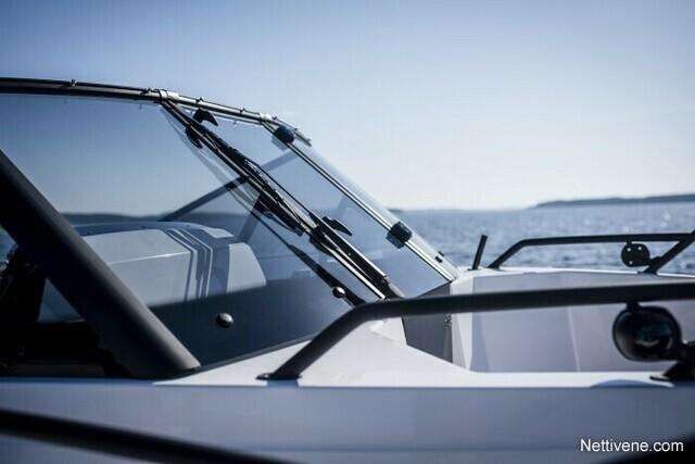 A close-up view of a boat's windshield against a serene ocean backdrop, highlighting sleek design and clear visibility.